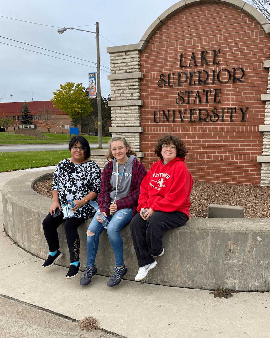 students-by-LSSU-sign-portrait